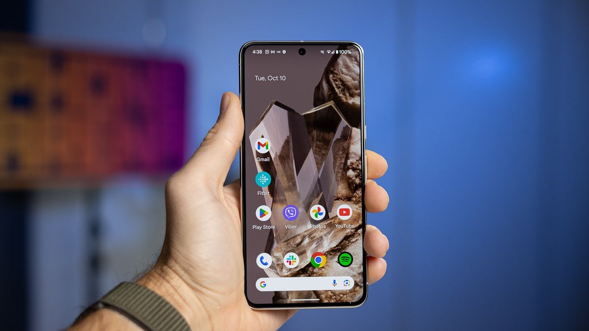 A person holds the Pixel 8 Pro in their hand, showcasing its display.