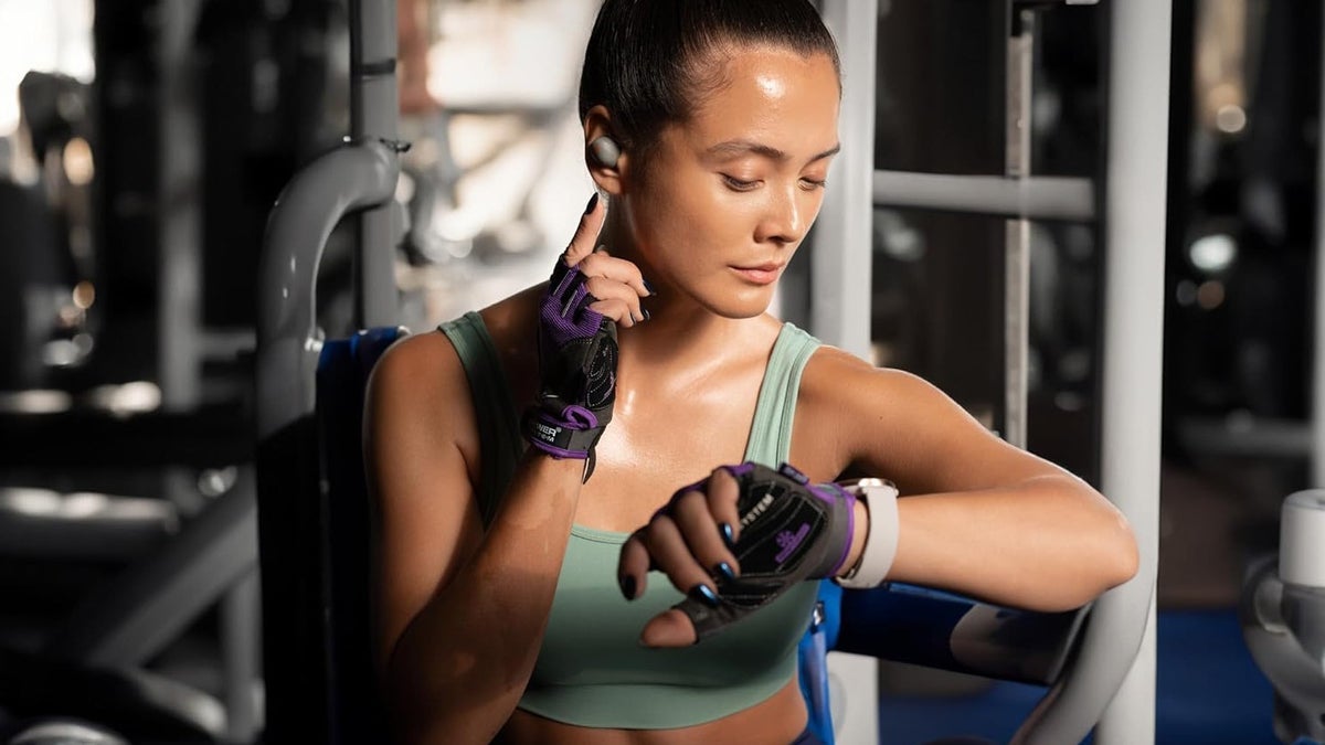 A woman wearing Sennheiser MOMENTUM Sport.