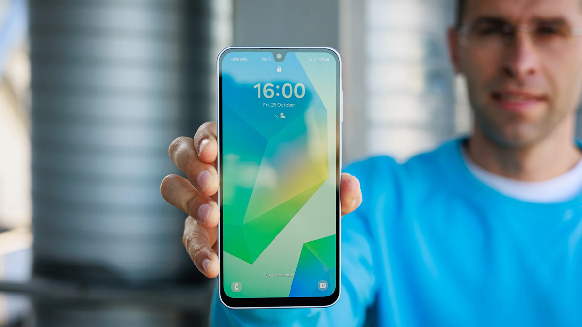 A close-up of the Galaxy A16, with the person holding it visible in the background.
