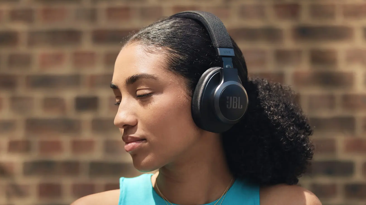 A woman wearing a set of JBL Live 770NC.