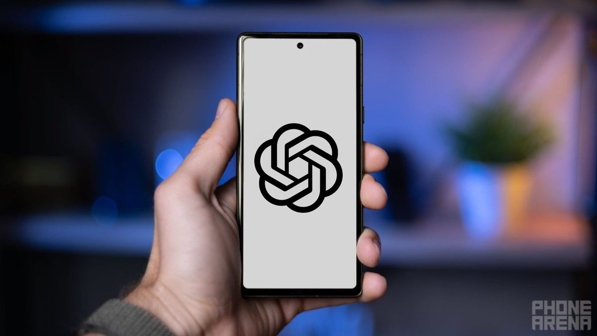 A hand holding a smartphone with ChatGPT's logo on the display.