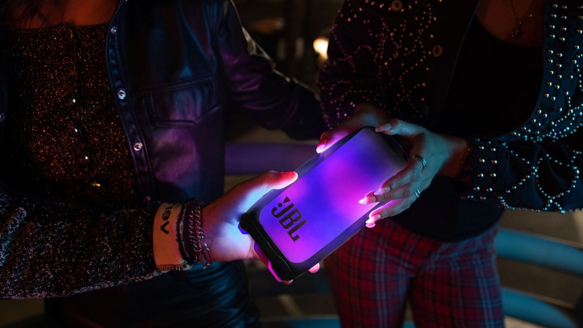 Two hands holding a JBL Pulse 5.