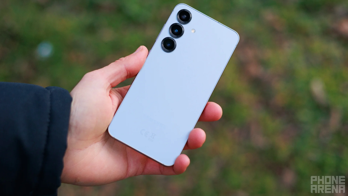 A photo of a person holding the Galaxy S25 in their hands.