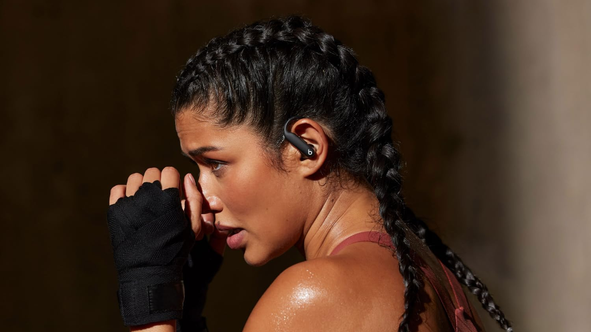 A profile view of a woman who's boxing while wearing the Beats Powerbeats Pro 2.