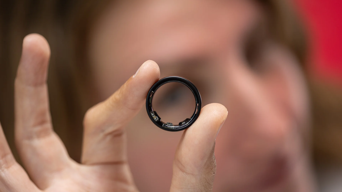 A close-up of the Galaxy Ring being held by a person.
