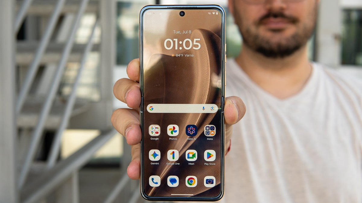 A person holds the Razr+ (2025) in Mocha Mousse, highlighting its beautiful design.