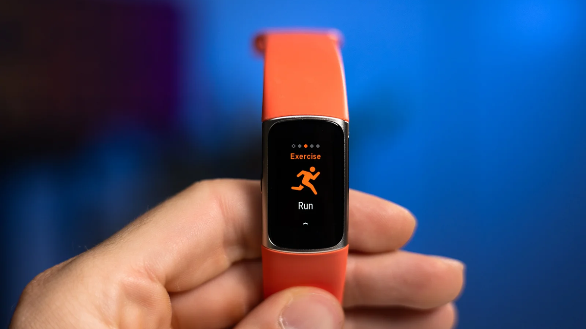 A person holds the Fitbit Charge 6, showcasing its vivid screen.