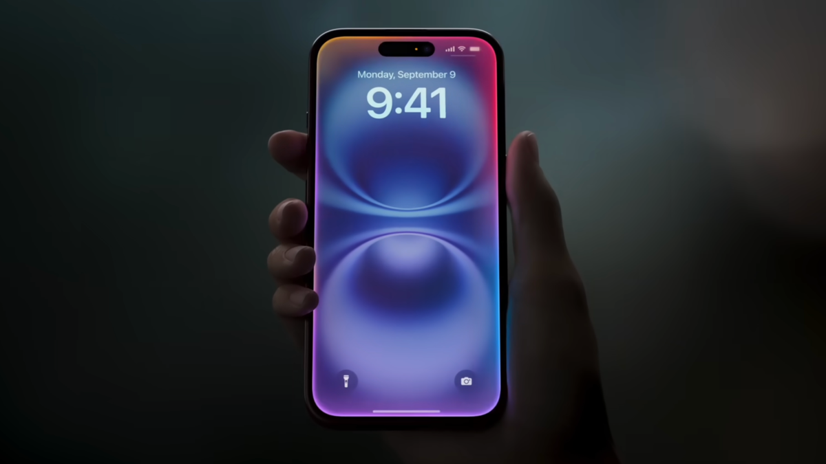 An image of a person's hand holding an iPhone in their hand.