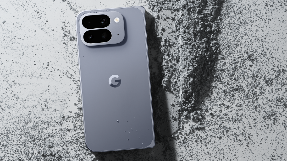 Back view of the new Pixel 10 Pro Fold, placed on a gray dust-like surface.