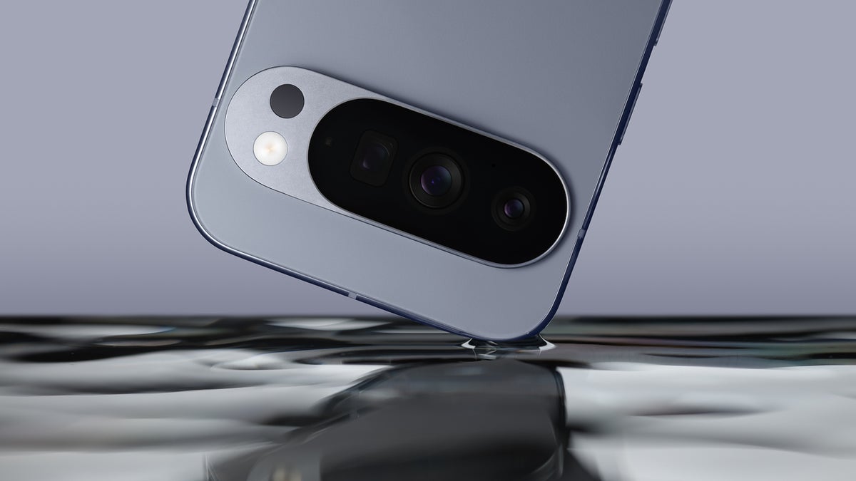 Close-up of the Pixel 10 Pro's rear camera module dipping into water.