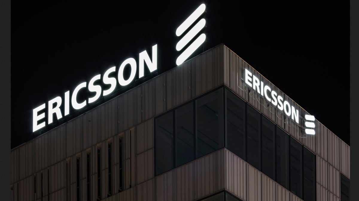 An Ericsson office building at night with the company name in lights