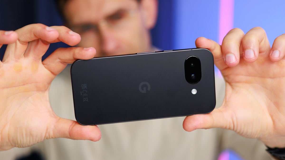Holding up the Google Pixel 9a in landscape mode with both hands