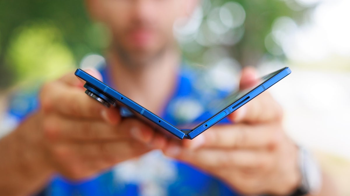 A close-up of the Galaxy Z Fold 7, being held half-folded by a person.
