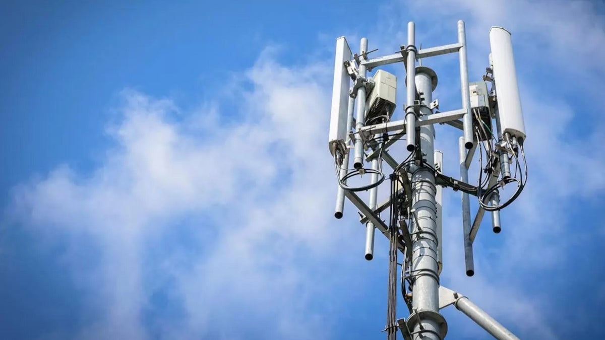 Picture of a cell tower against the sky.