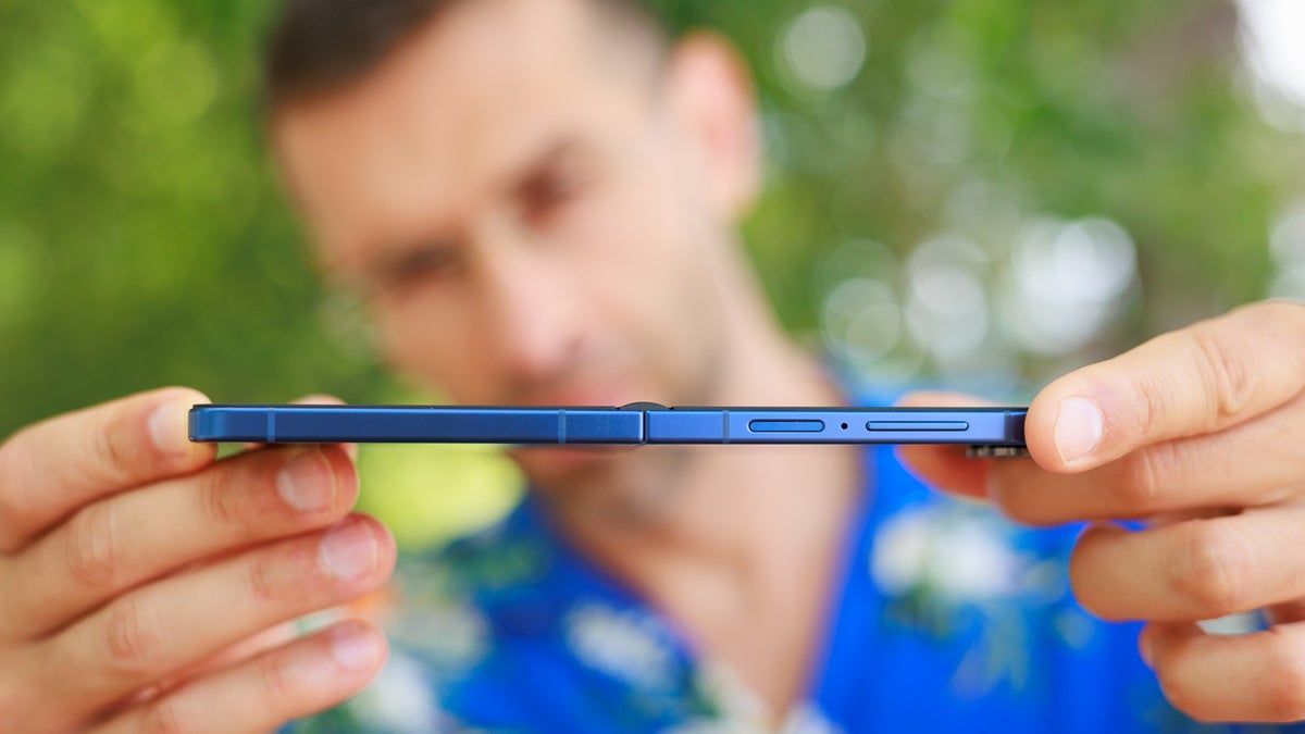 A close-up of the Galaxy Z Flip 7 being held unfolded by a person.