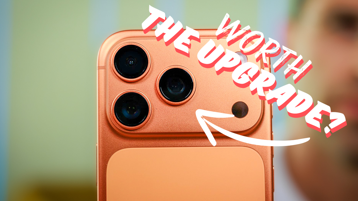 Close-up of an orange smartphone with triple cameras and bold text reading “Worth the upgrade?” with an arrow pointing at the camera module.