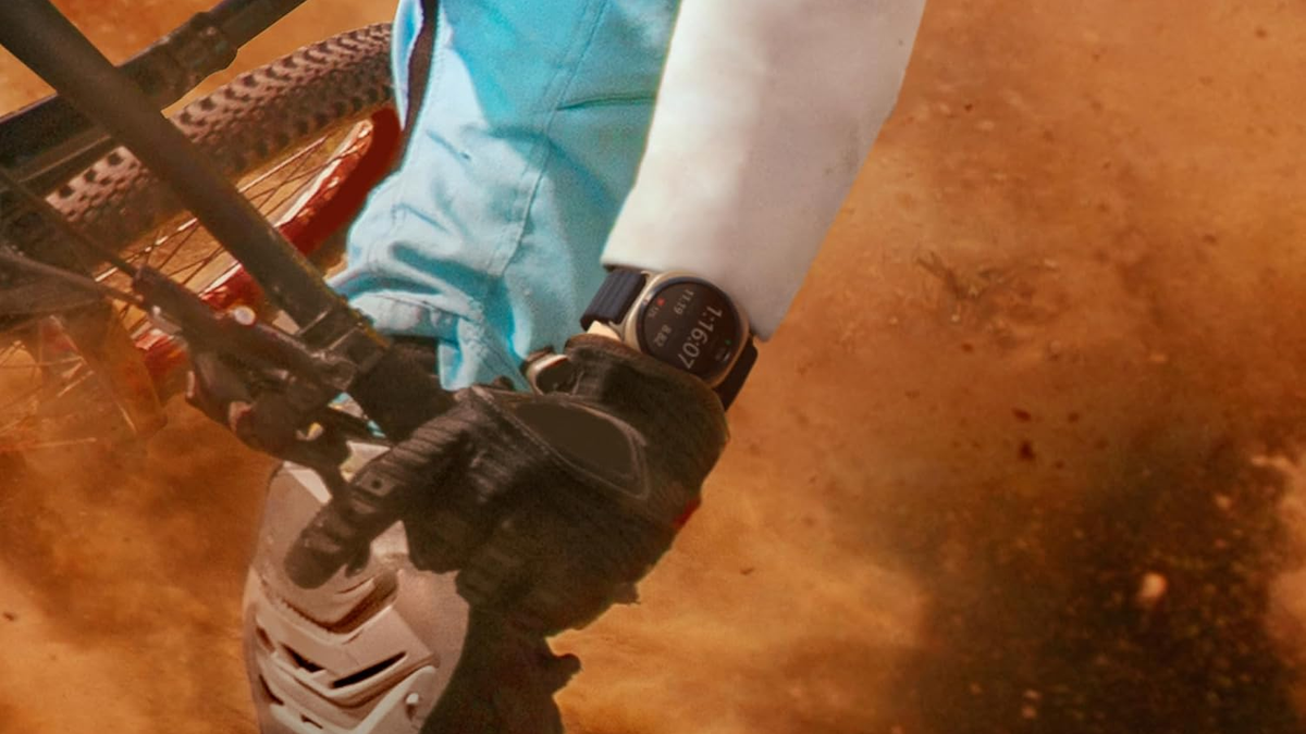 A person riding a mountain bike while wearing the Galaxy Watch Ultra (2025).