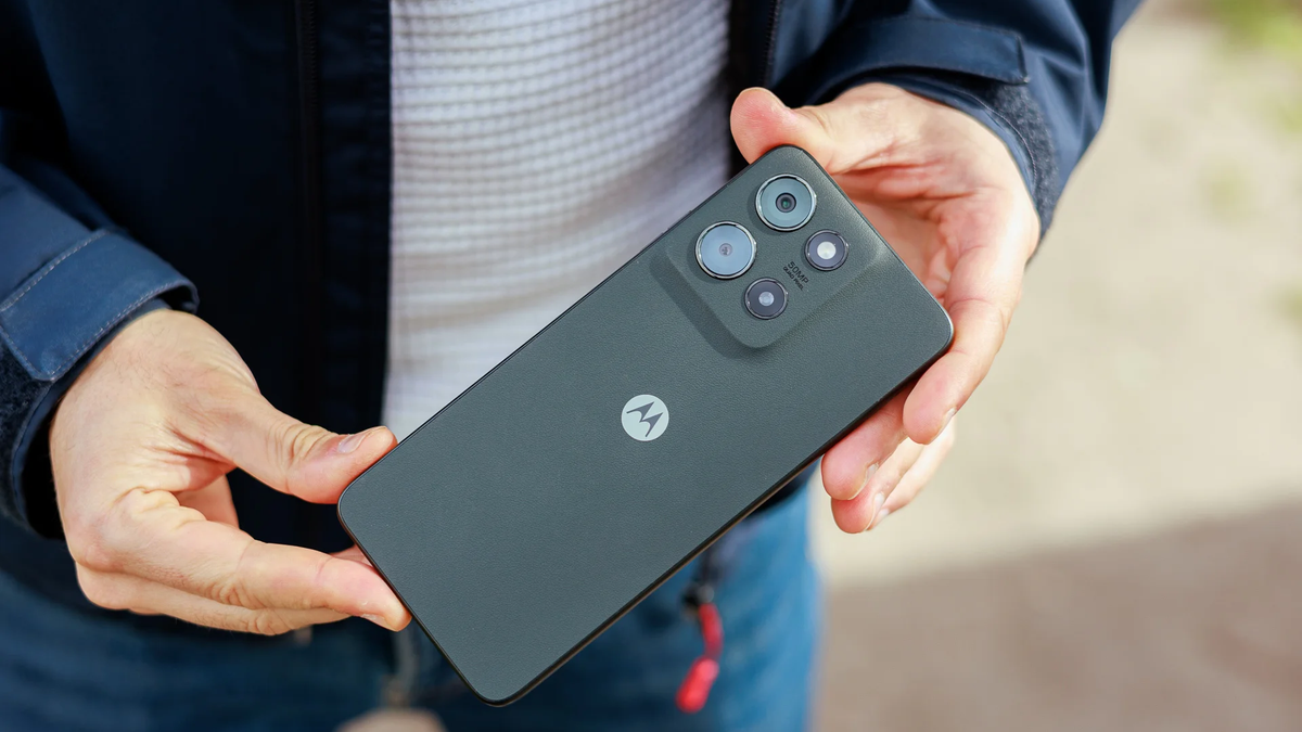 A person holds the Moto G (2025), showing the phone's rear design and camera module.