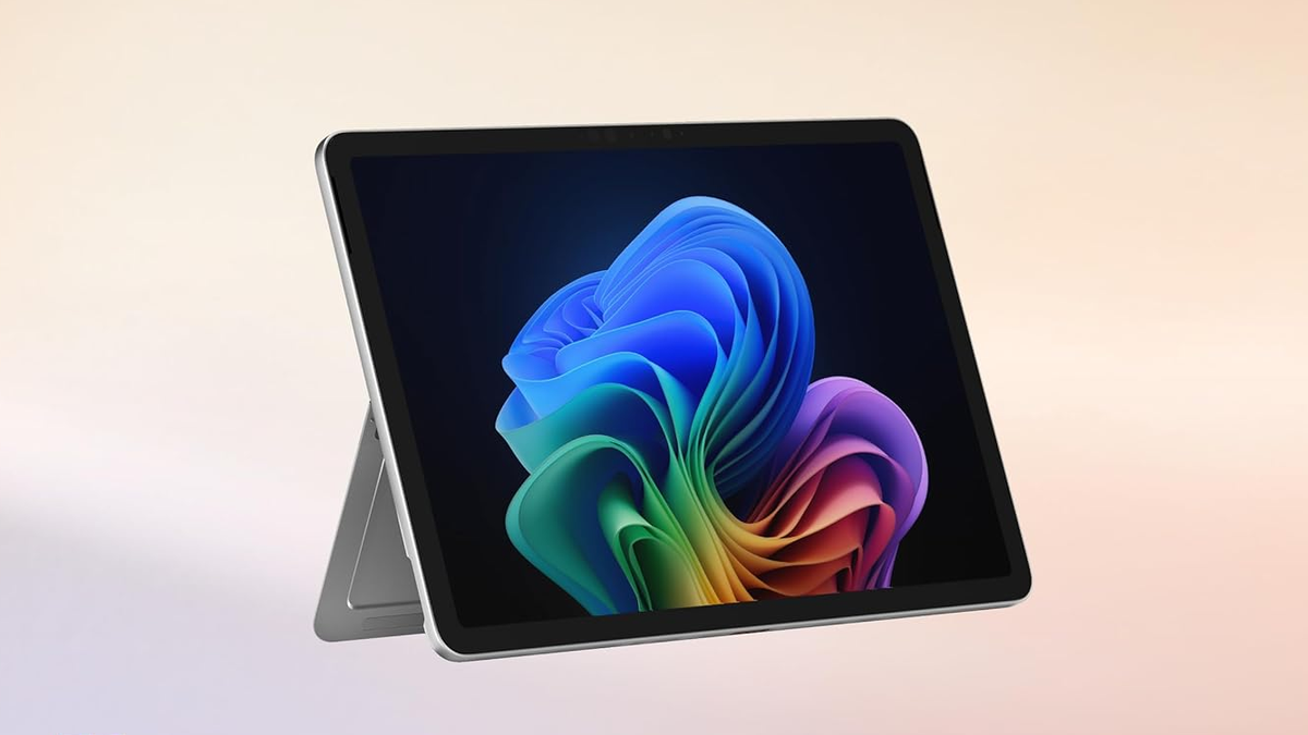 Surface Pro 12 tablet on a peach-colored background.