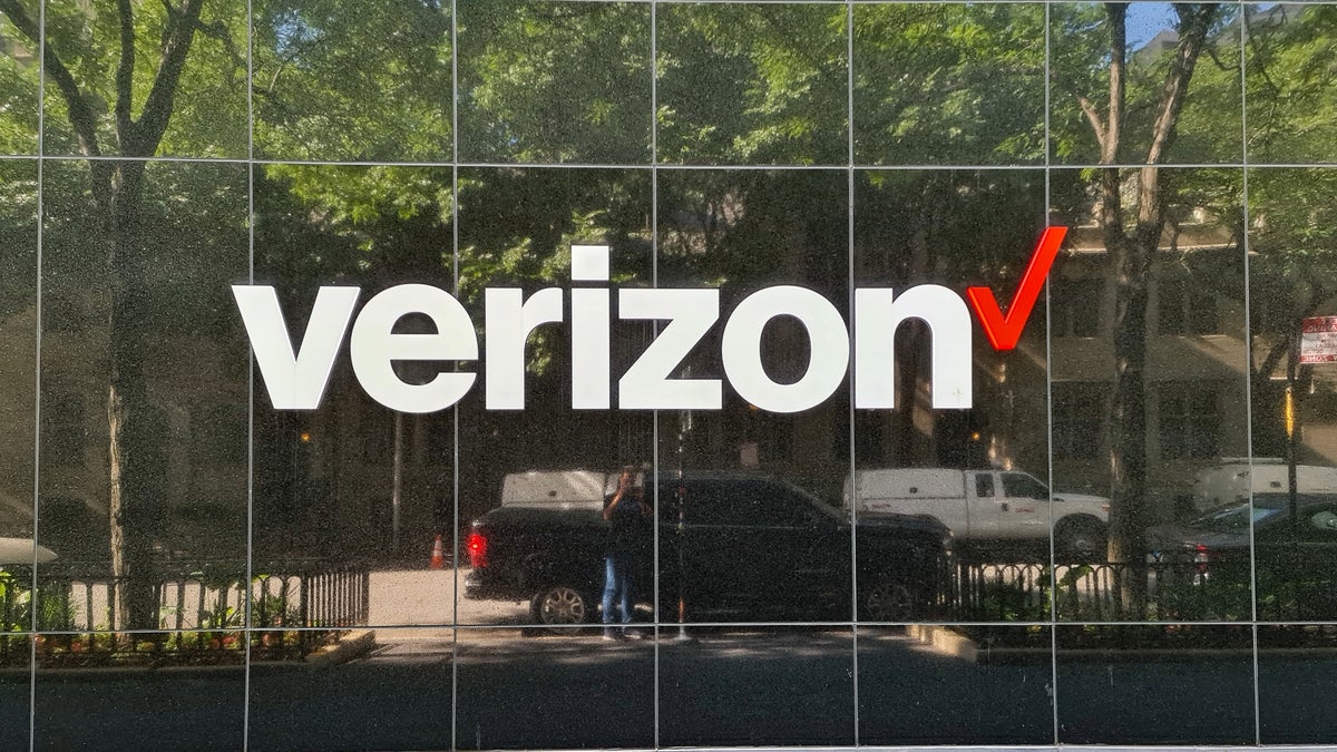 A photo showing Verizon's logo displayed on glass building.