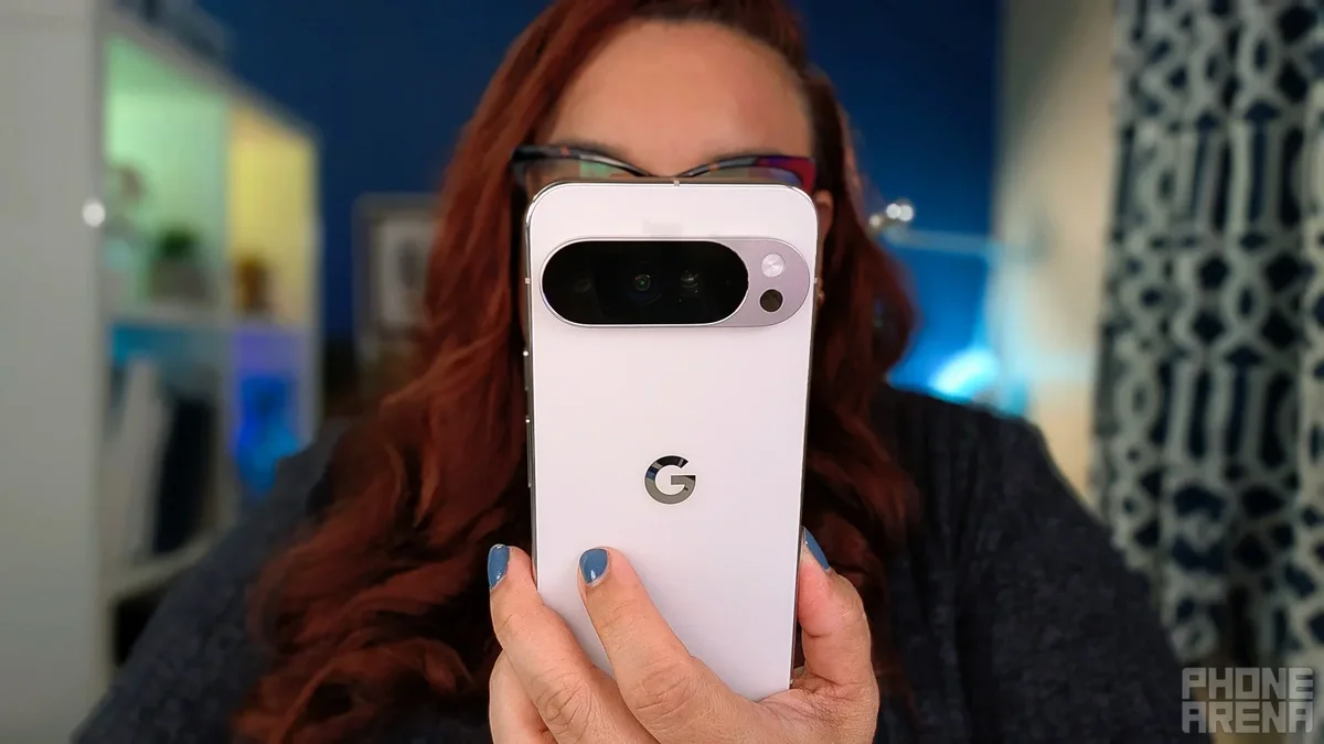 The Pixel 10 Pro XL is held in a user's left hand.