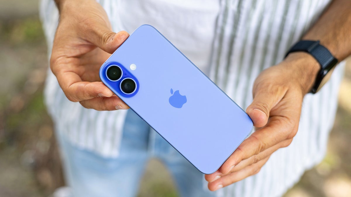 A person holding the iPhone 16 in their hands.