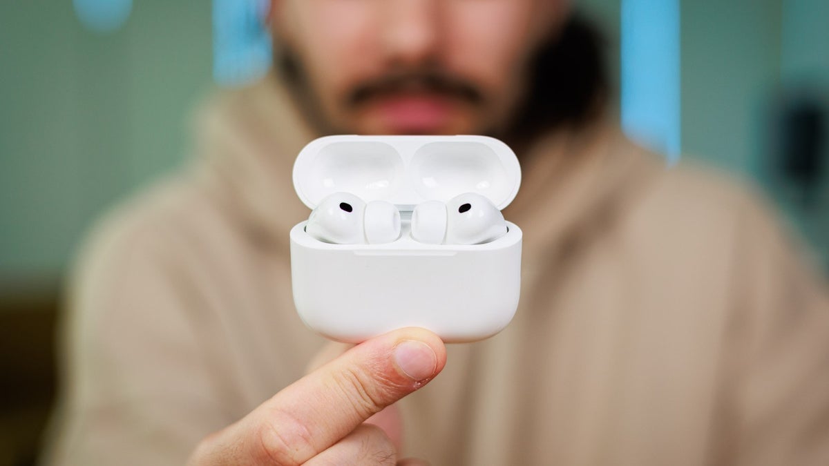 A person holding the AirPods Pro 3.