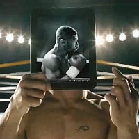 Manny Pacquiao gently handles an HP TouchPad in the tablet's first TV ad