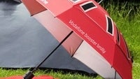 Umbrella boosts cell phone signal, charges batteries, protects from rain