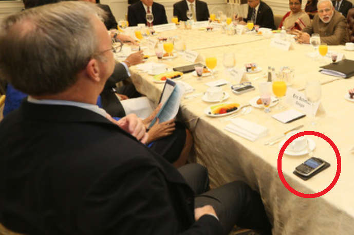 Eric Schmidt at the adults' table sporting the BlackBerry Bold 9900 and an unidentified Android phone - Guess who still uses a BlackBerry? (A BlackBerry Bold 9900 to be exact)