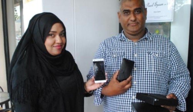 Huawei's Hawa Hyath (L) presents Siraaj Abrahams with a Huawei P9 lite - Huawei P8 lite takes two bullets for its owner; company responds with a free upgrade to the P9 lite