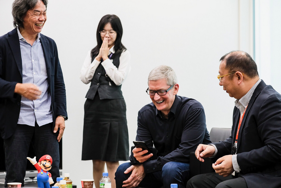 As Mario creator Shigeru Miyamoto (at left) looks on, Apple CEO Tim Cook previews Super Mario Run for iOS - Tim Cook meets Nintendo executives in Japan, gets to play a preview of the first Mario iOS game