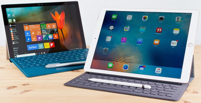 Surface Pro 4 behind an iPad Pro with a keyboard cover and Apple Pencil - Microsoft CEO gloats that iPad Pro ended up being a whole lot like the Surface line