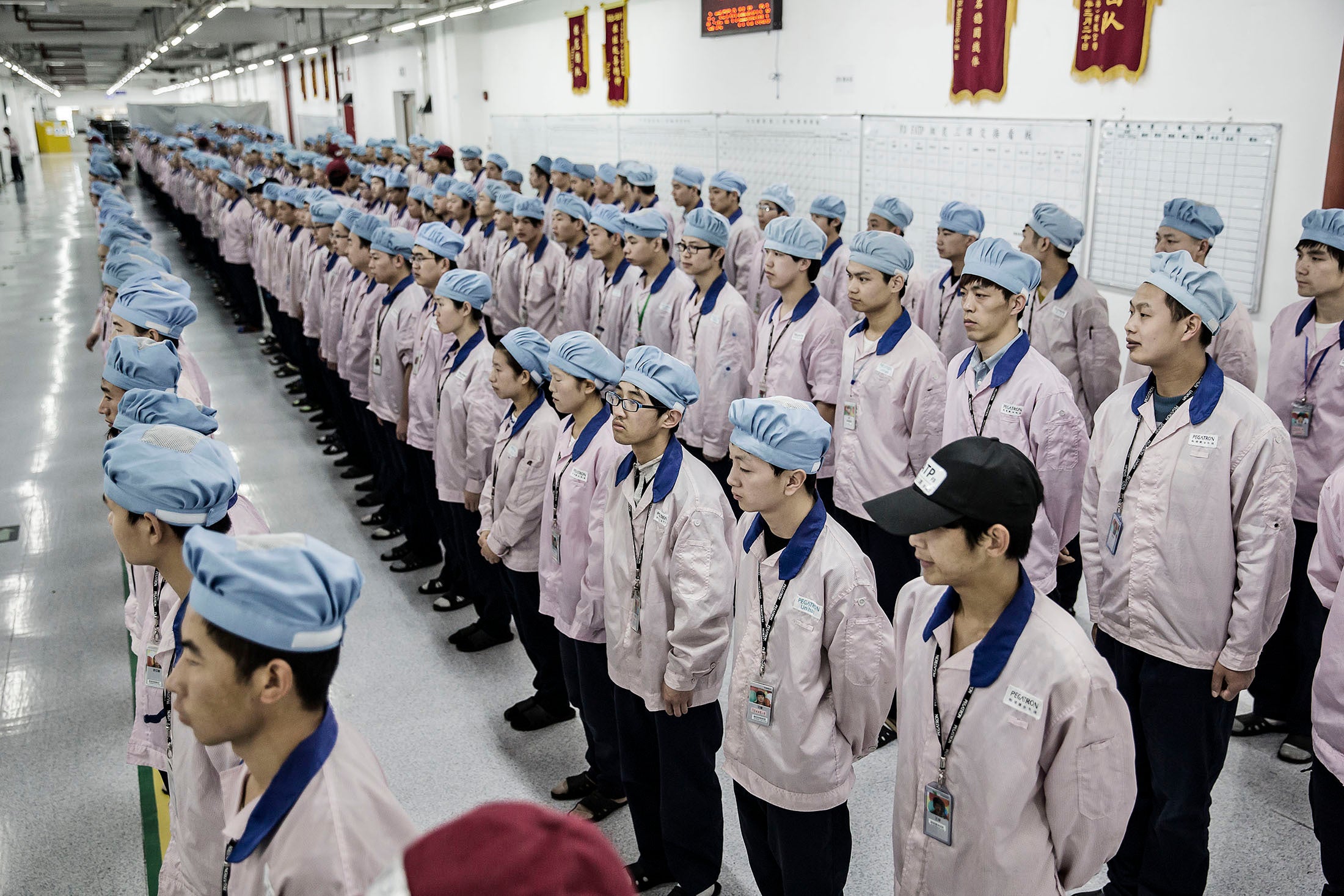 Pegatron assembly workers line up before knocking out a 10-12 hour shift putting together iPhones. Such a scene is not so viable in the US. Photo credit - Bloomberg - Apple making iPhones in the United States? Do not hold your breath