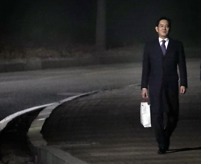 Jay Y. Lee exited the detention center, carrying a white shopping bag (courtesy of The Korea Herald). - Samsung's boss walks free, prosecutors still on his case