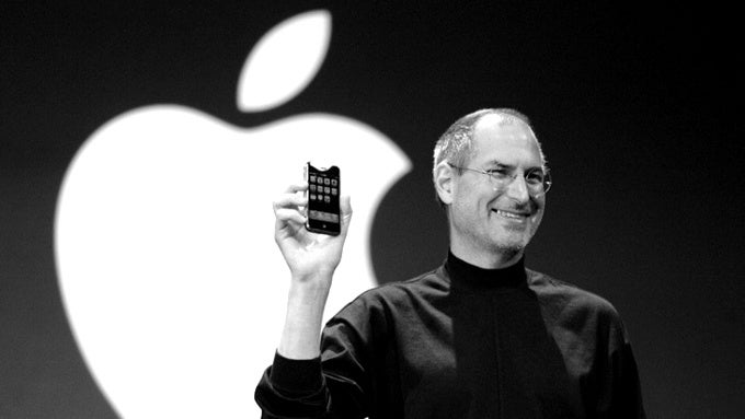 Steve Jobs holding the original iPhone - Apple iPhone vs Samsung Galaxy: a history of the biggest smart phone rivalry