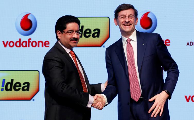 Kumar Mangalam Birla (left), chairman of Aditya Birla Group, shaking hands with Vittorio Colao (right), CEO of Vodafone Group, following the announcement of the merger between the two companies - $23 billion deal spells the creation of an Indian telecom giant with 400 million subscribers