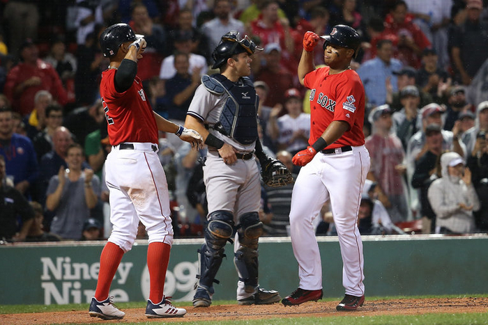 Red Sox celebrate a home run hit by Rafael Devers (R) on August 18th in Fenway Park; could that hit have been the result of Red Sox trainers using an Apple Watch to pass along signs stolen from the Yankee's catcher ? - Boston Red Sox accused of stealing opponent's signs using the Apple Watch