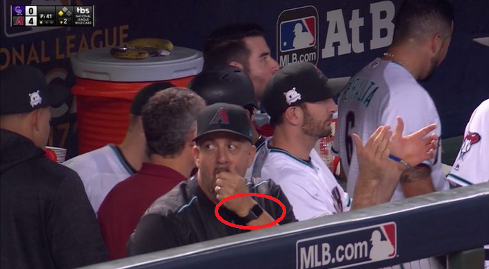 Arizona coach Ariel Prieto is seen on MLB TV&#039;s broadcast of Wednesday night&#039;s Diamondbacks-Rockies game wearing an Apple Watch in the dugout - MLB Coach fined for wearing an Apple Watch in the dugout