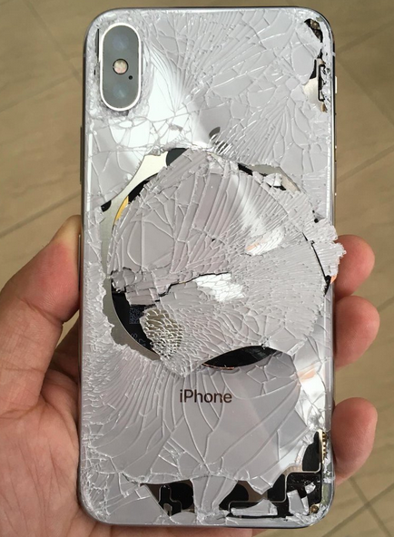 Back glass of an Apple iPhone X is shattered after the phone was dropped - If you don't put a case on your Apple iPhone X, it could end up looking like this!