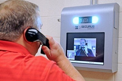 A Securus video phone used in prison - NYT: Data sharing service helps law enforcement track any cellphone in seconds