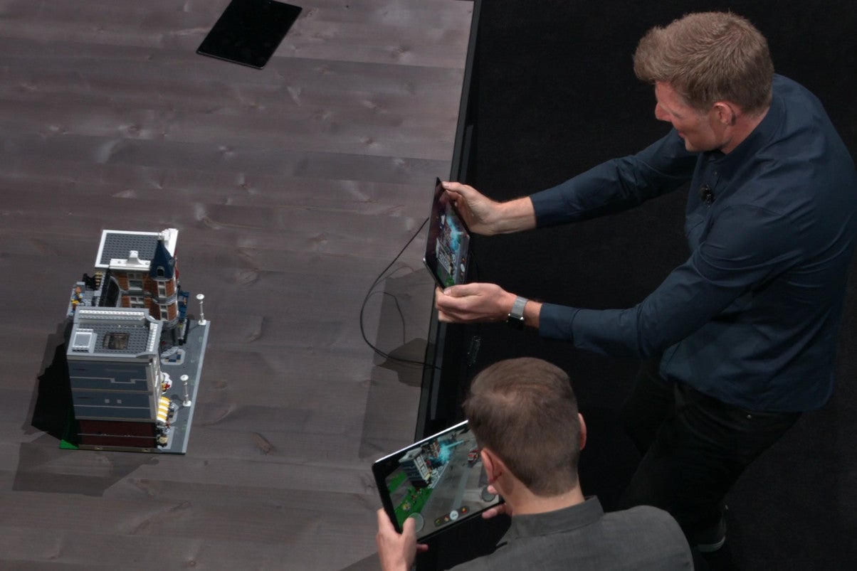 Two guys playing an AR Lego game, pretending to be having fun. - Apple&#039;s latest keynote proves we still don&#039;t know what to do with augmented reality