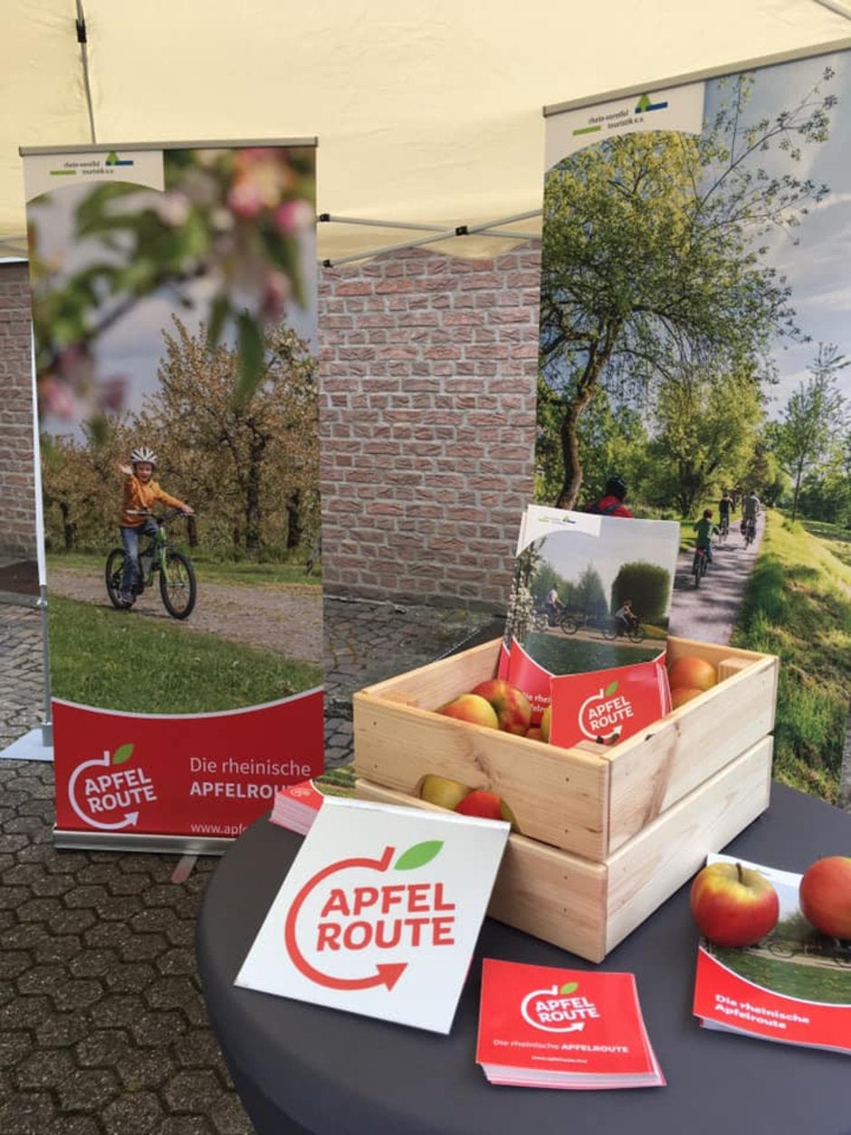 The Apfelroute marketing materials are all ready for the grand opening on May 18 - Bitten fruit and right-leaning leaf do not an Apple logo make (results)