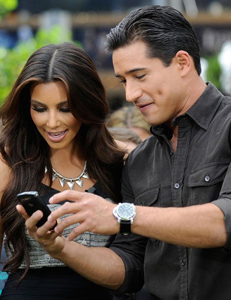 Mario Lopez entertains Kim Kardashian with his BlackBerry Torch