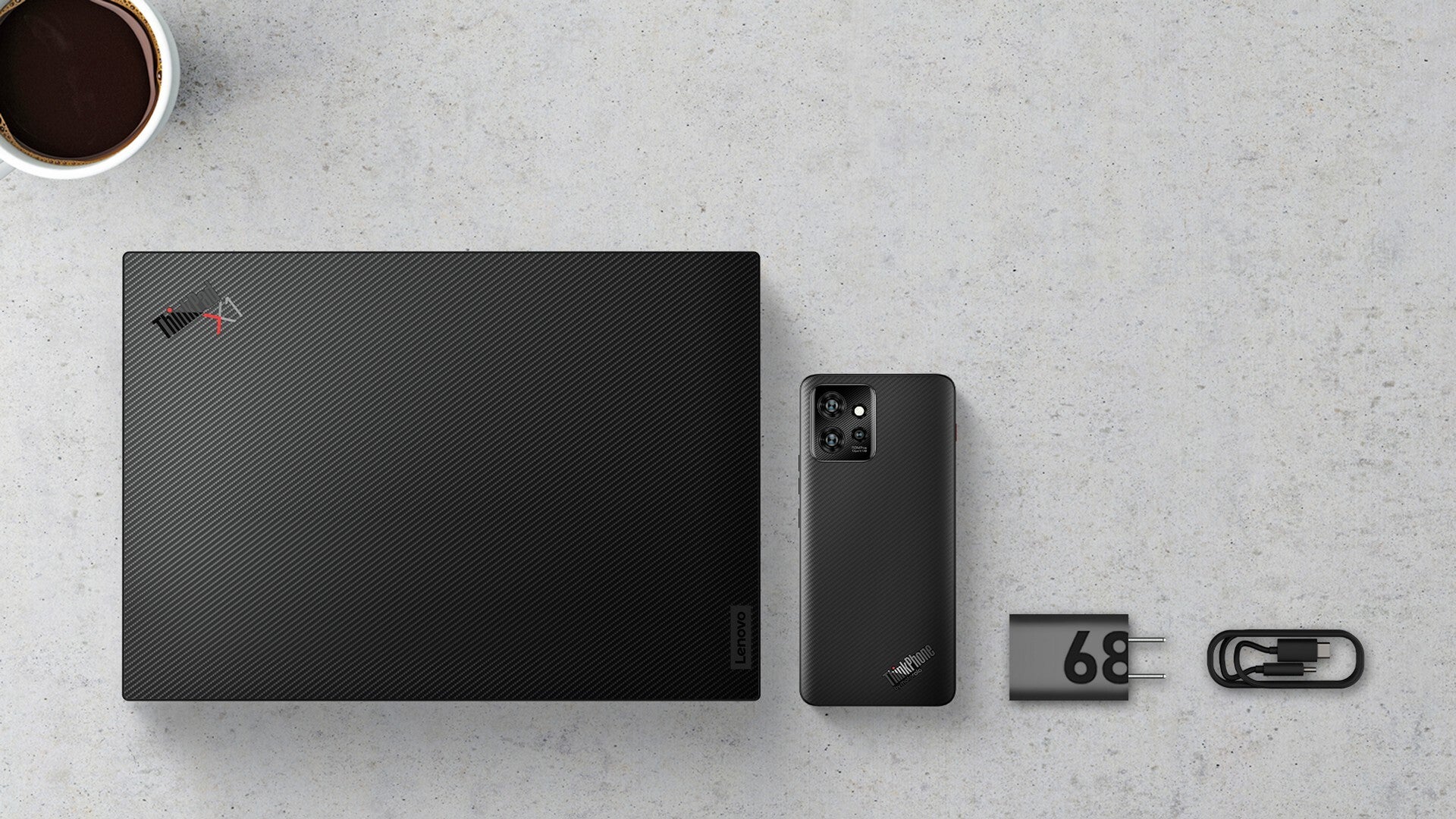Lenovo ThinkPhone, its 68W power adapter, and the ThinkPad X1 Carbon Gen 11. - Motorola announces its first jab at a business-centric phone: the Lenovo ThinkPhone