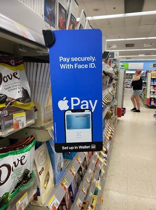 Apple Pay sign hangs inside a Salem Walgreen's store - Check out the new promo videos for Apple Pay