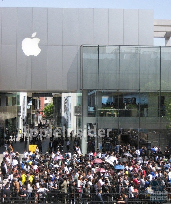 Long lines wait outside an Apple Store in China for the Apple iPad 2 - Launch of Apple iPad 2 in China turns ugly; four are hospitalized