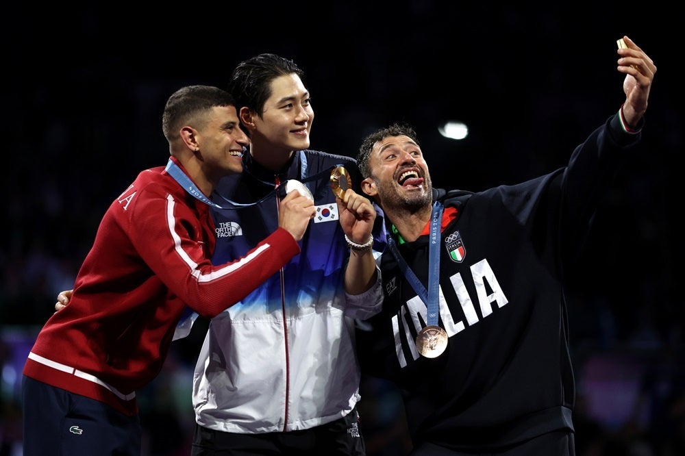 From left – Silver medalist Fares Ferjani of Team Tunisia, gold medalist Sanguk Oh of Team Republic of Korea and bronze medalist Luigi Samele of Team Italy pose for their Victory Selfie after the men’s sabre individual fencing competition. | Photo by Patrick Smith, Getty Images - What is the Galaxy Victory Selfie, and why it&#039;s so darn hard to take one (Gallery)