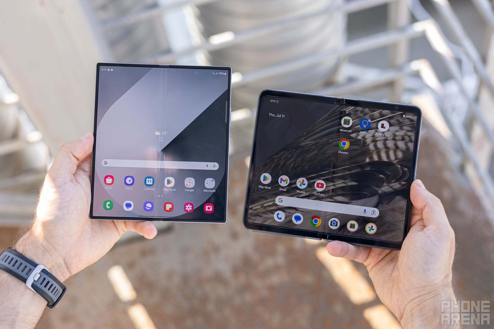 An image of the Samsung Galaxy Z Fold 6 and Google Pixel Fold being held up by a person