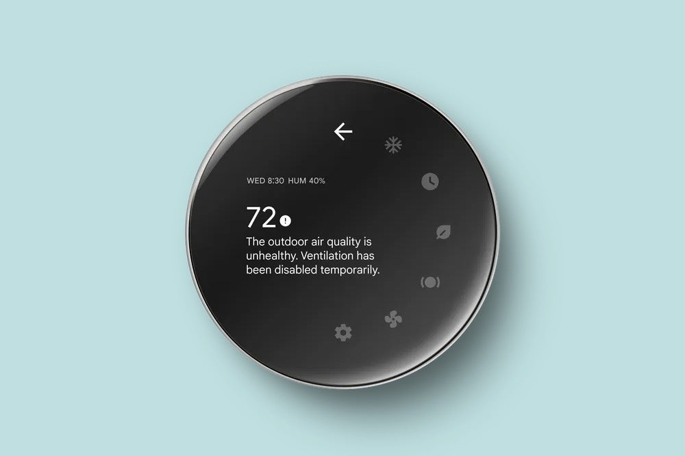 A Nest Learning Thermostat with the screen displaying the temperature